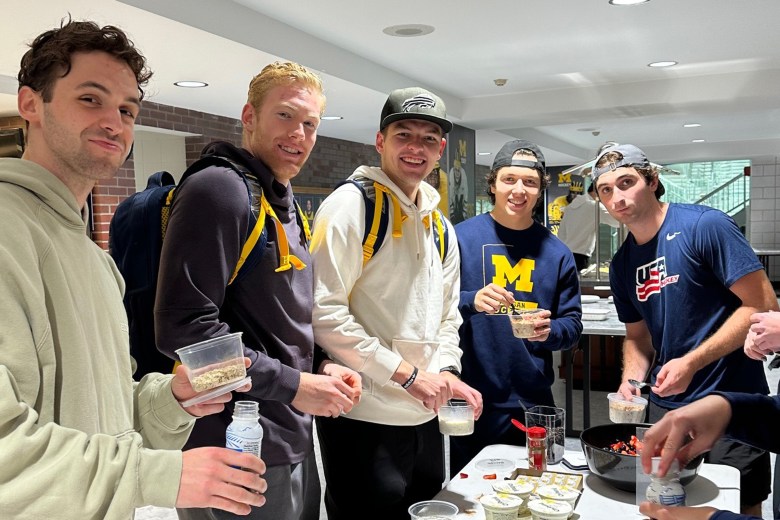 The Michigan hockey team smiles for a photo.